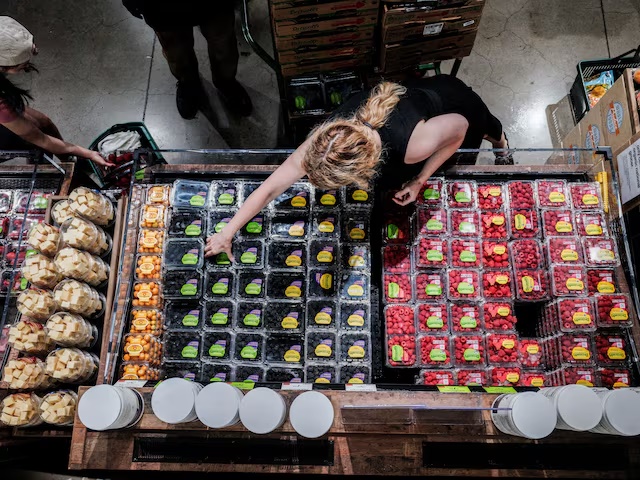 People shop for groceries at a store in New York City, U.S., July 15, 2025. REUTERS/Jeenah Moon/File Photo