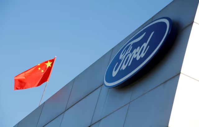 The Chinese national flag flies on the roof of a Ford car dealership in Beijing, China October 11, 2018. REUTERS/Thomas Peter