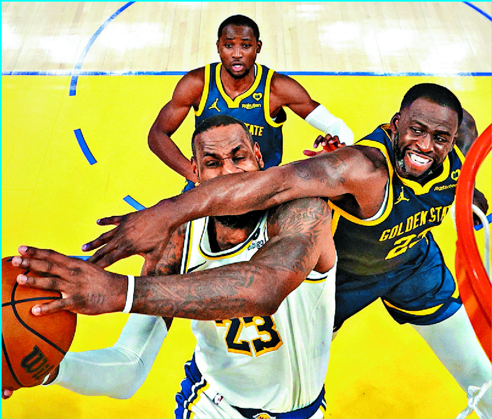 LeBron James is fouled by Draymond Green. AFP LeBron James is fouled by Draymond Green. AFP