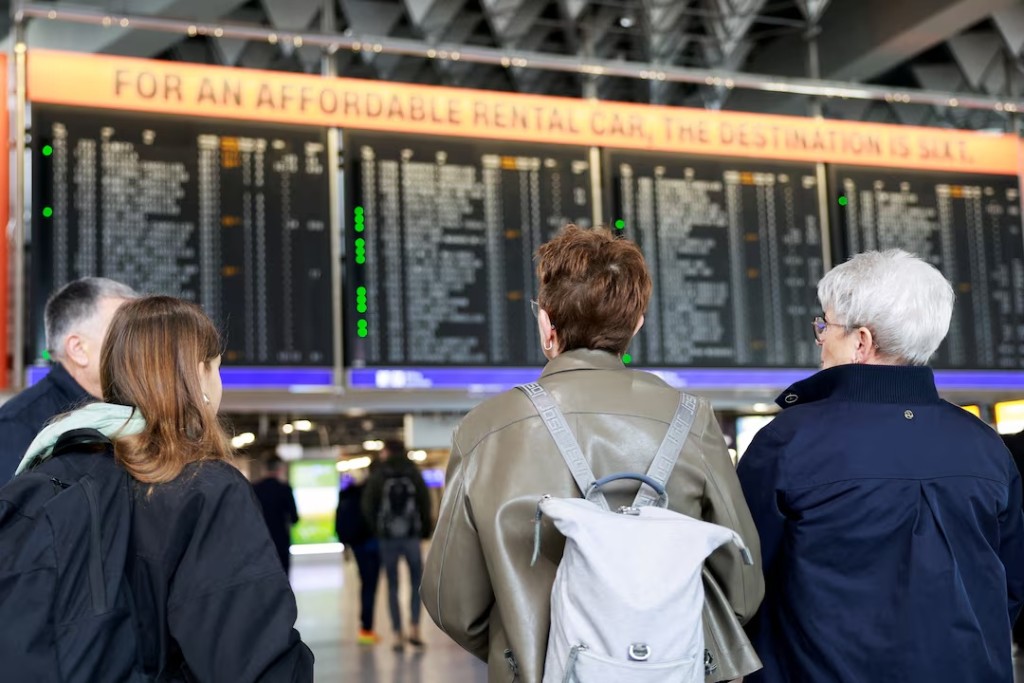 People look at information panels that show flights, many of which are cancelled, during a strike by the UFO union, representing Lufthansa cabin crew, at Frankfurt Airport, Germany, April 10, 2026. REUTERS/Heiko Becker