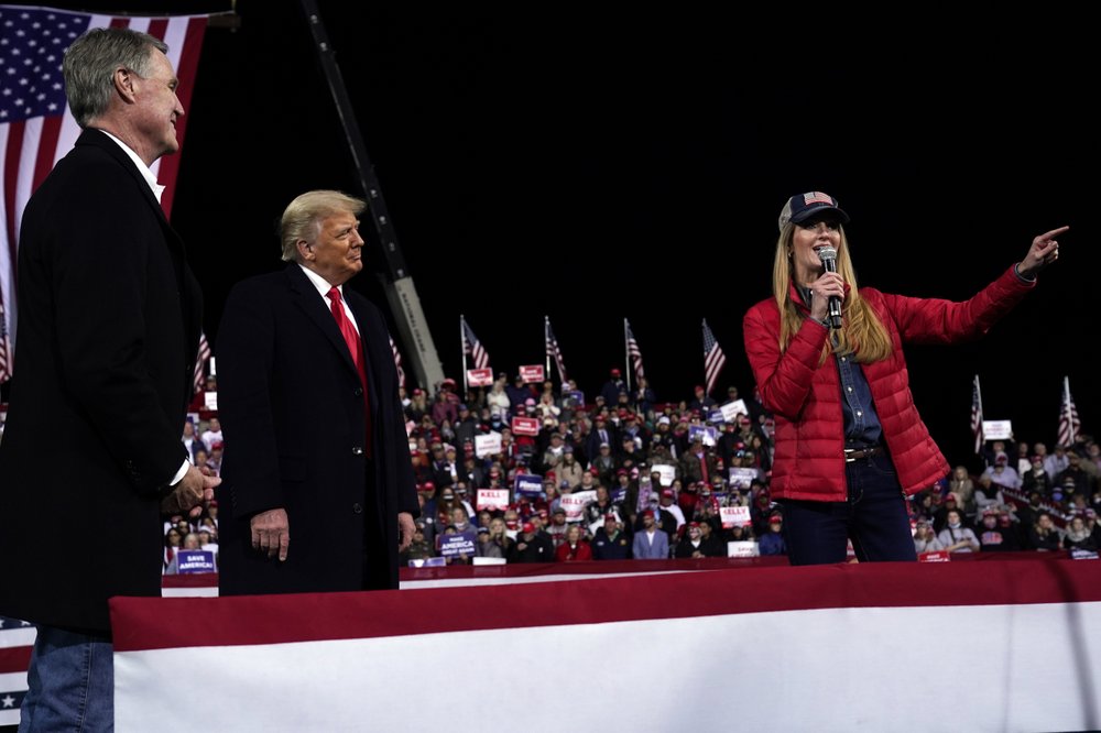 Georgia's Republican Senator Kelly Loeffler, speaks as President Donald Trump and Senator David Perdue, listen at a campaign rally at Valdosta Regional Airport, Saturday, December 5, 2020. Georgia's Republican Senator Kelly Loeffler, speaks as President Donald Trump and Senator David Perdue, listen at a campaign rally at Valdosta Regional Airport, Saturday, December 5, 2020.