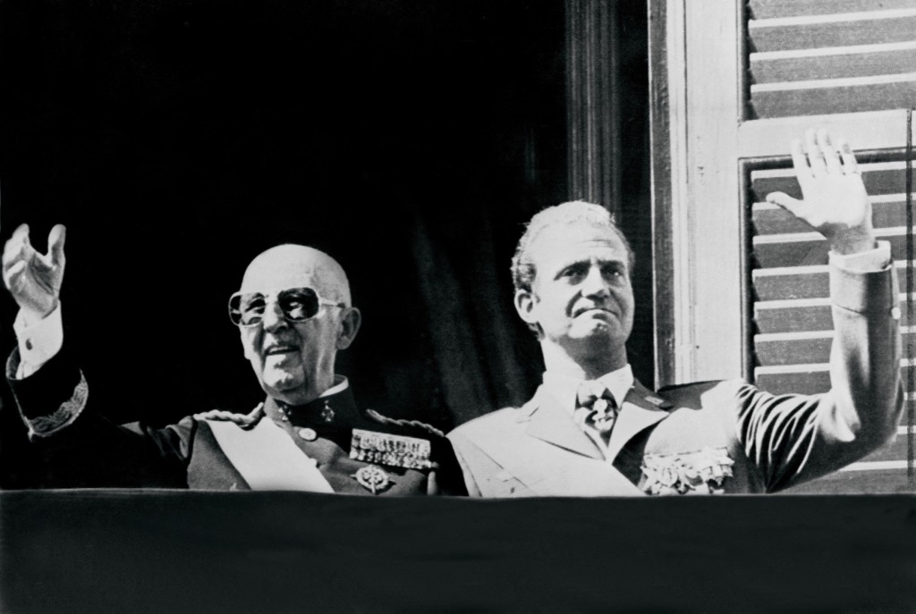 Photo by STRINGER / TT NEWS AGENCY / AFP  Spanish head of state General Francisco Franco (L) and prince Juan Carlos salute the crowd in Madrid in October 1975.