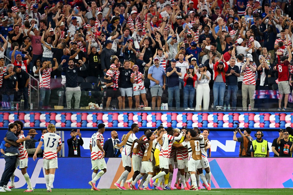 S midfielder #07 Giovanni Reyna celebrates with teammates after scoring his team's fourth goal during the 2026 World Cup Group D football match between USA and Paraguay at the Los Angeles Stadium in Inglewood on June 12, 2026. (Photo by Patrick T. Fallon / AFP)