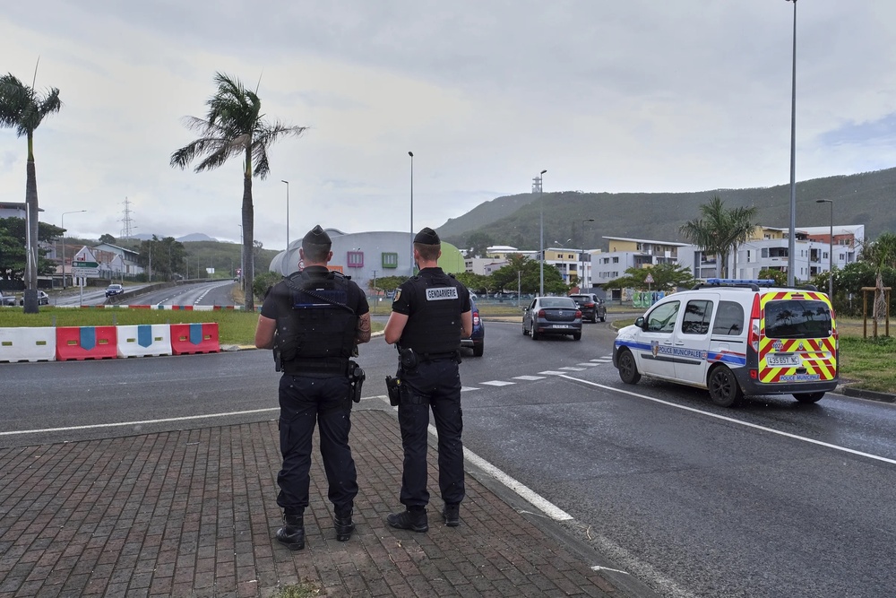 FILE - French gendarme patrol at a roundabout in Noumea, New Caledonia, Sunday Dec.12, 2021. At least two people were killed and three were seriously injured overnight in the French Pacific territory of New Caledonia, French officials there said Wednesday, May 15, 2024, as President Emmanuel Macron convened a meeting of top ministers to discuss the spiraling violence. (AP Photo/Clotilde Richalet, File) FILE - French gendarme patrol at a roundabout in Noumea, New Caledonia, Sunday Dec.12, 2021. At least two people were killed and three were seriously injured overnight in the French Pacific territory of New Caledonia, French officials there said Wednesday, May 15, 2024, as President Emmanuel Macron convened a meeting of top ministers to discuss the spiraling violence. (AP Photo/Clotilde Richalet, File)