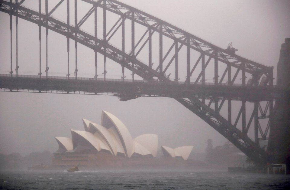 A boat passes under the Sydney Harbour Bridge and in front of the Sydney Opera House as strong winds and heavy rain hit the city of Sydney, Australia. (Reuters) A boat passes under the Sydney Harbour Bridge and in front of the Sydney Opera House as strong winds and heavy rain hit the city of Sydney, Australia. (Reuters)