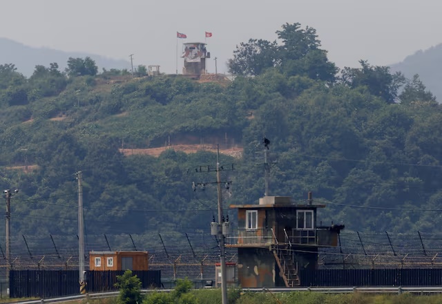 A North Korean soldier stands guard at his guard post inside North Korean territory, in this picture taken from Paju, South Korea, near the demilitarized zone (DMZ) separating the two Koreas, June 17, 2020. REUTERS/Kim Hong-Ji/File Photo