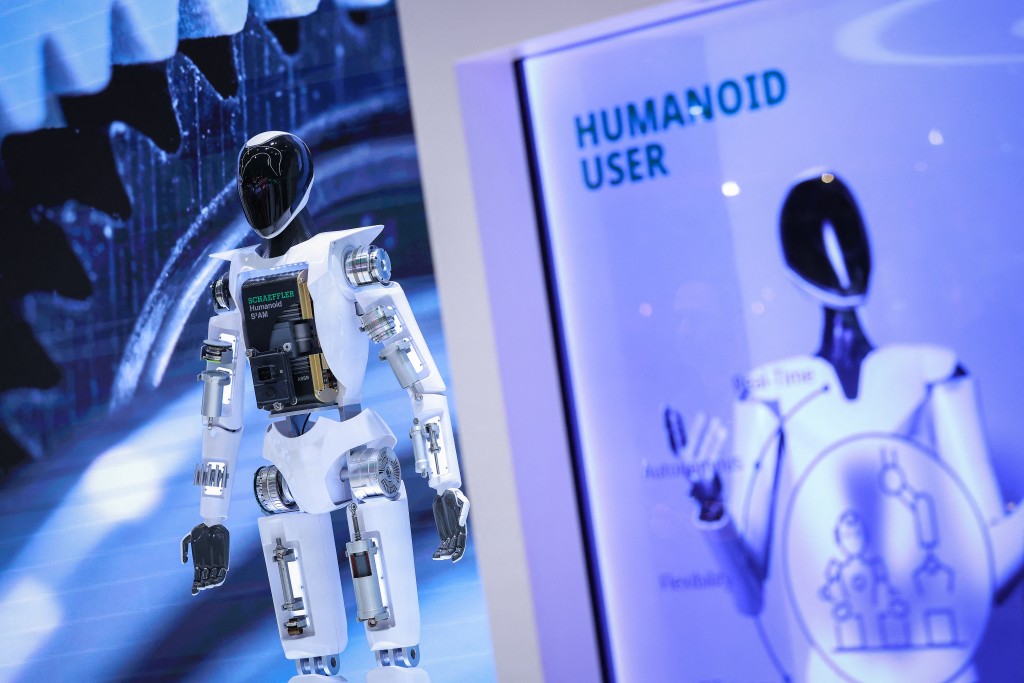 Photo by RONNY HARTMANN / AFP  A humanoid robot is seen at the booth of Automotive supplier Schaeffler AG company during a tour of the Hannover industrial trade fair for mechanical and electrical engineering and digital industries, in Hannover, northern Germany on April 20, 2026.