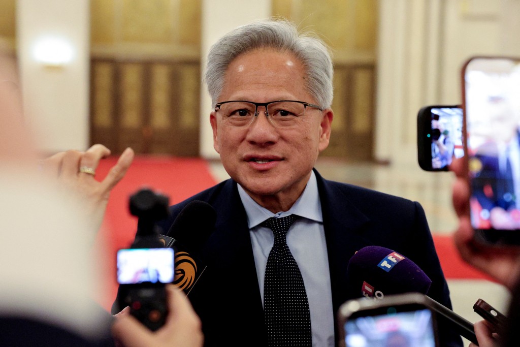 Nvidia CEO Jensen Huang speaks to the media on the day he attends a meeting between Chinese Premier Li Qiang and U.S. business representatives, at the Great Hall of the People in Beijing, China May 14, 2026. REUTERS