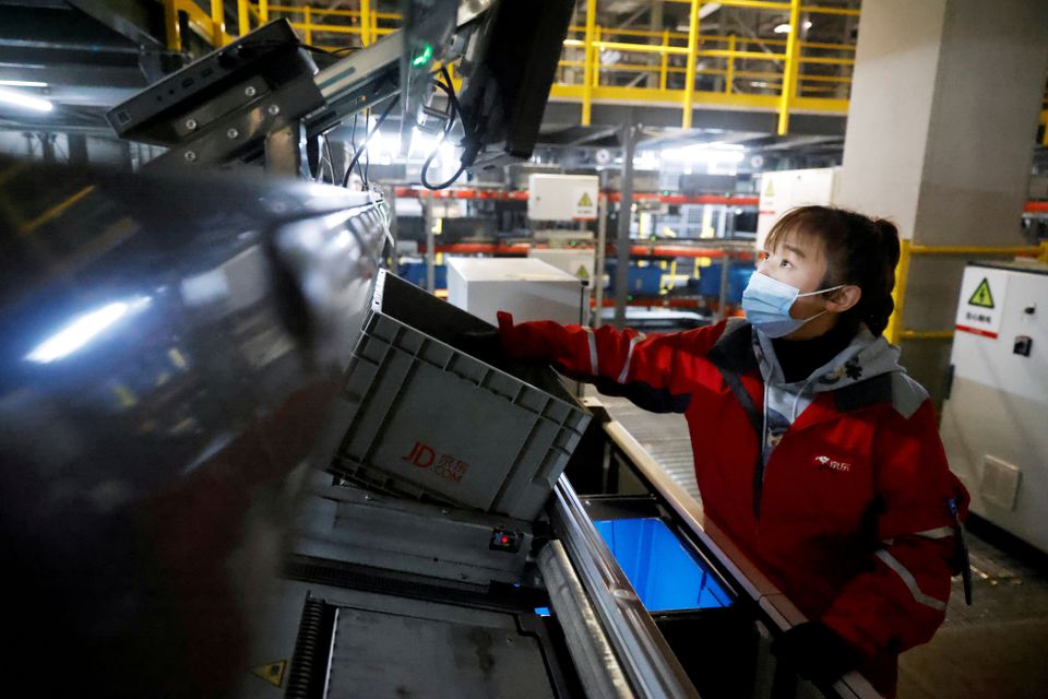 A worker at JD.com's automated logistics center during a government organized tour on China's Singles Day shopping festival in Beijing, November 11, 2020. A worker at JD.com's automated logistics center during a government organized tour on China's Singles Day shopping festival in Beijing, November 11, 2020.