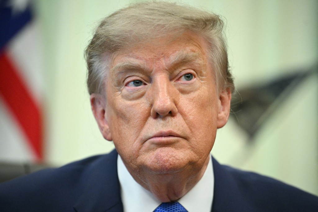 Photo by JIM WATSON / AFP  US President Donald Trump looks on before signing an executive order calling for more research and flexibility on vaccines, in the Oval Office of the White House in Washington, DC, on August 10, 2026.