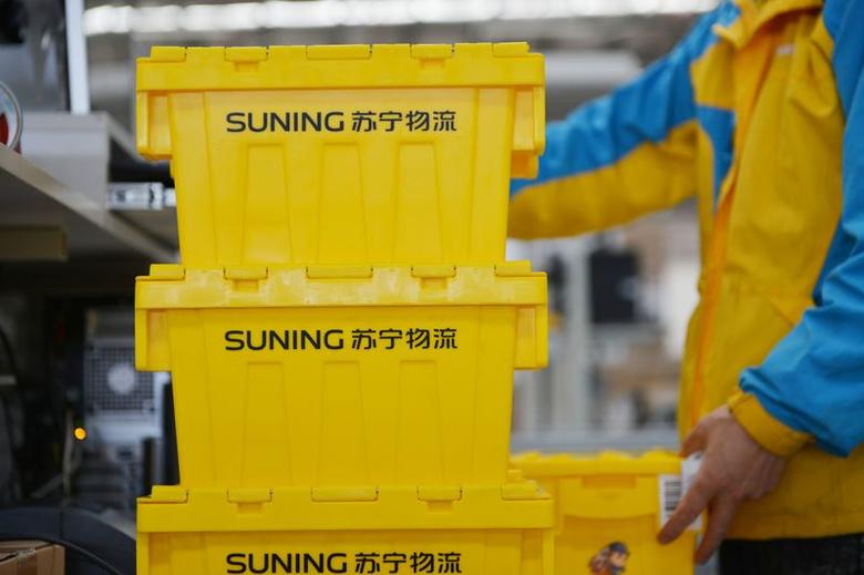 An employee of Suning piles up reusable boxes to be delivered at a logistics center ahead of the Singles Day online shopping festival in Nanjing, Jiangsu province, China October 28, 2017 An employee of Suning piles up reusable boxes to be delivered at a logistics center ahead of the Singles Day online shopping festival in Nanjing, Jiangsu province, China October 28, 2017