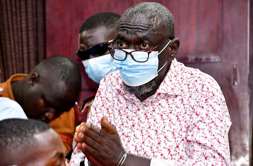 Detained Ugandan opposition figure Kizza Besigye gestures before he collapsed while attending a court session where he is on trial for treason, at the High court in Kampala, Uganda, July 29, 2026. REUTERS/Abubaker Lubowa