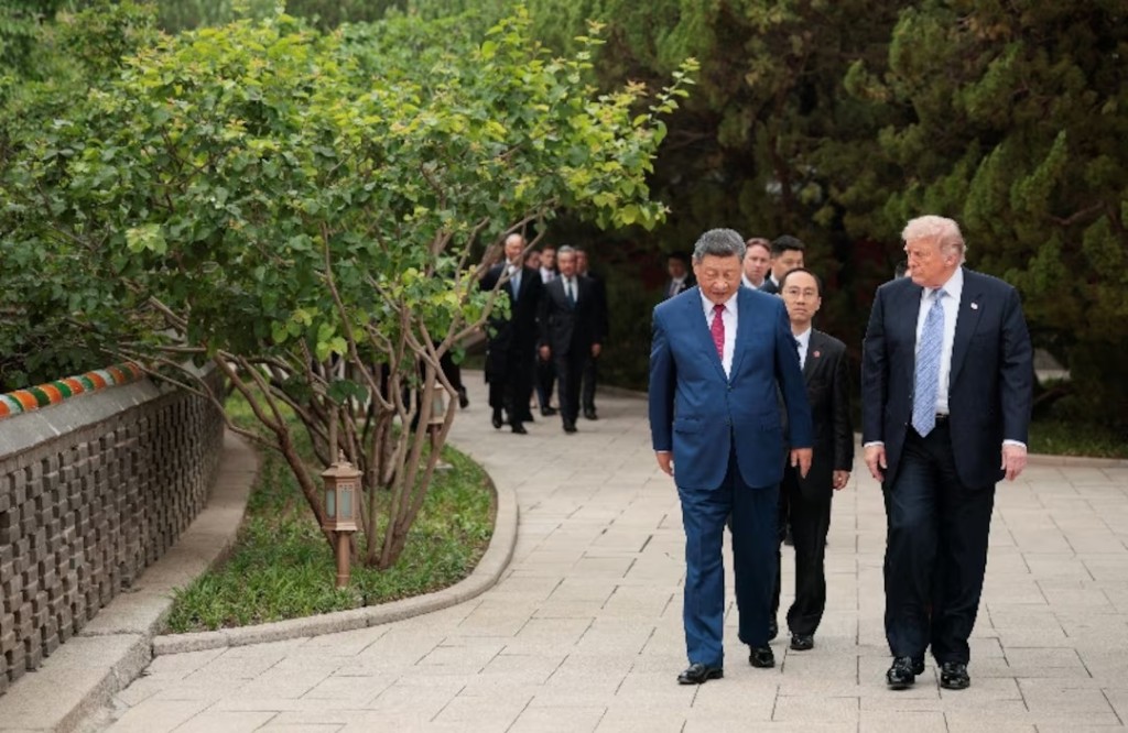 U.S. President Donald Trump walks with Chinese President Xi Jinping while leaving after a visit to the Zhongnanhai Garden in Beijing, China, May 15, 2026. REUTERS/Evan Vucci/Pool
