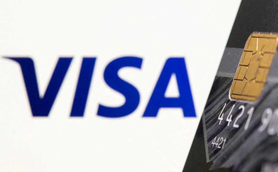 Credit card is seen in front of displayed Visa logo. (Reuters) Credit card is seen in front of displayed Visa logo. (Reuters)