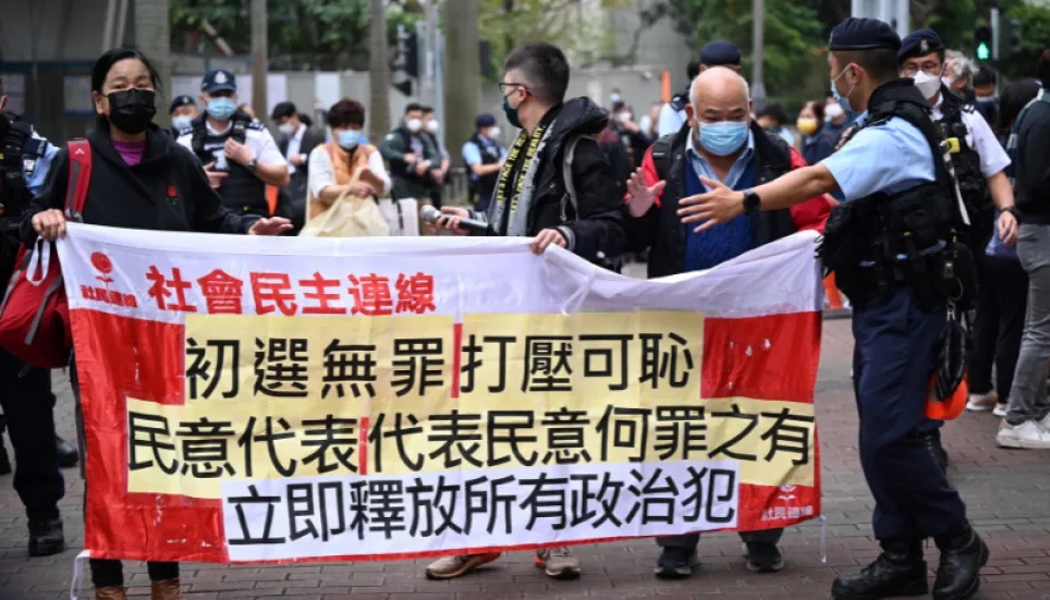 Members of the League of Social Democrats carry a banner outside a court in Hong Kong on February 6, 2023 as the trial of 47 of Hong Kong’s most prominent pro-democracy figures begins in the largest prosecution under a national security law that has crushed dissent in the city. — AFP Photo Members of the League of Social Democrats carry a banner outside a court in Hong Kong on February 6, 2023 as the trial of 47 of Hong Kong’s most prominent pro-democracy figures begins in the largest prosecution under a national security law that has crushed dissent in the city. — AFP Photo