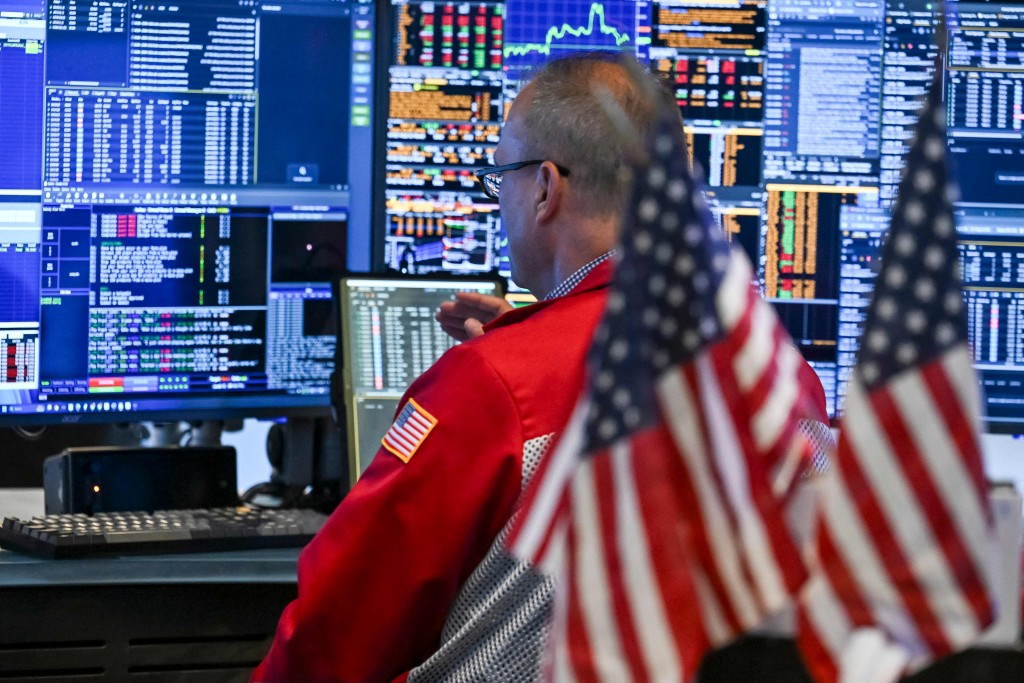 Traders work on the floor of the New York Stock Exchange (NYSE) at the closing bell, in New York City on July 23, 2026. AFP