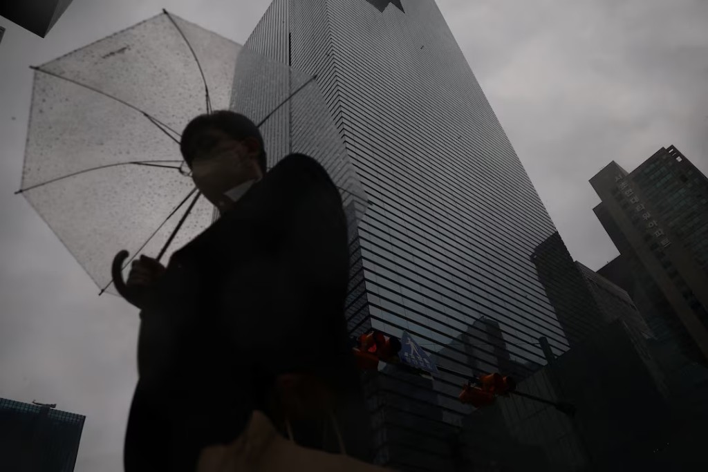 An employee holding an umbrella walks in front of Samsung Electronics office building as it rains in Seoul, South Korea, May 20, 2026. REUTERS/Kim Hong-Ji 