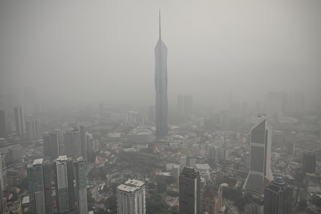 Photo by JAM STA ROSA / AFP  Buildings are shrouded in haze caused by fires in Indonesia, in Kuala Lumpur on October 16, 2026.