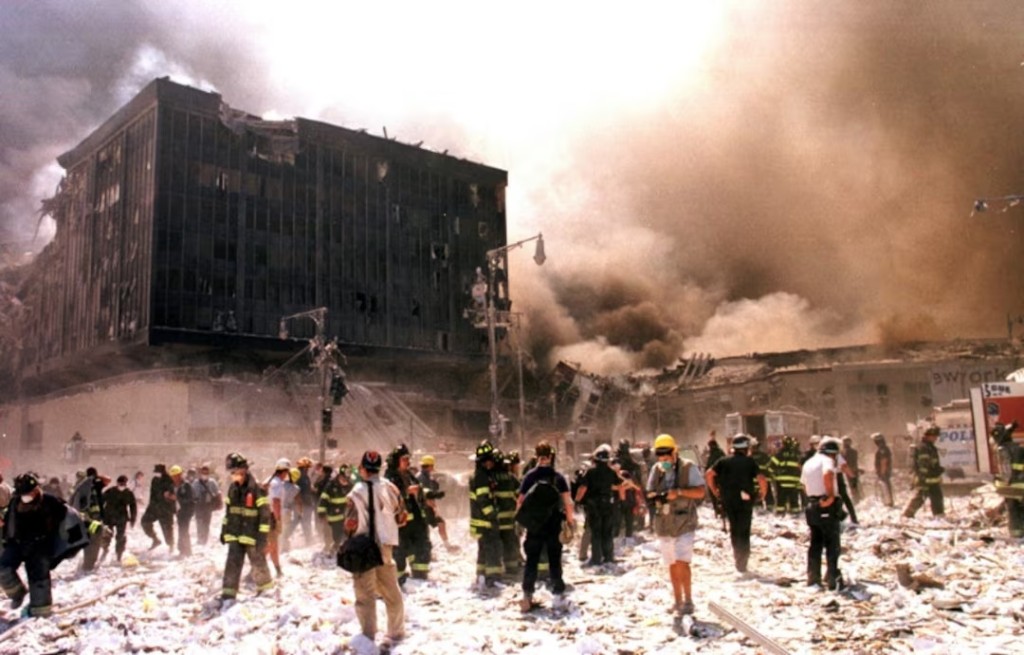 New York City firefighters and other emergency personnel battle building blaze after the World Trade Center buildings collapse September 11, 2001. Three hijacked planes slammed into the [Pentagon] and New York's landmark World Trade Center on Tuesday, demolishing the two 110-story towers that symbolize U.S. financial might./File Photo