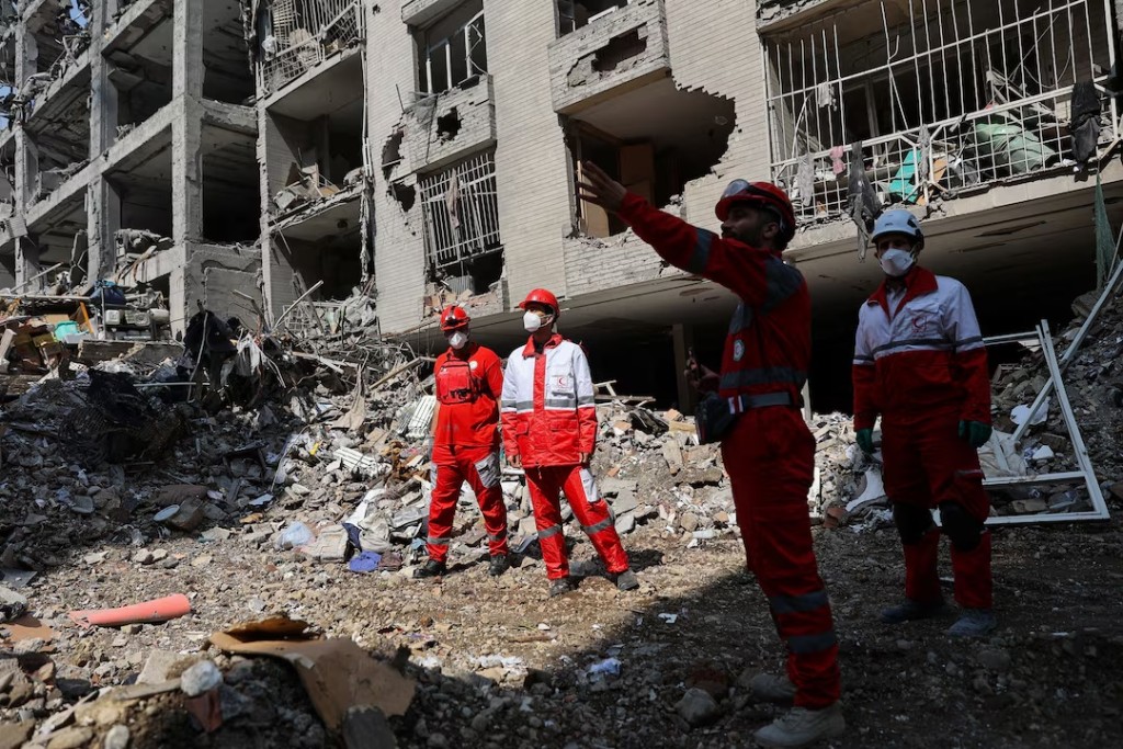 Members of a Red Crescent rescue team work at a building that was damaged by a strike, amid the U.S.-Israeli conflict with Iran, in Tehran, Iran, March 17, 2026. Majid Asgaripour/WANA (West Asia News Agency) via REUTERS
