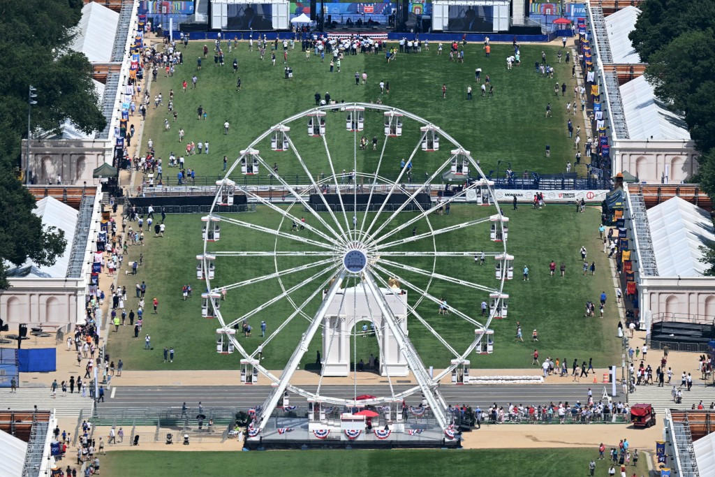 Photo by ALEX WROBLEWSKI / AFP The Ferris wheel is seen with the US Capitol in the distance during the “Great American State Fair" as seen from the Washington Monument on the National Mall in Washington, DC, on June 30, 2026.