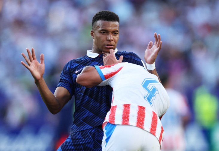 France star Kylian Mbappe is pushed by Paraguay’s Juan Jose Caceres during their last-16 match in Philadelphia. AFP 