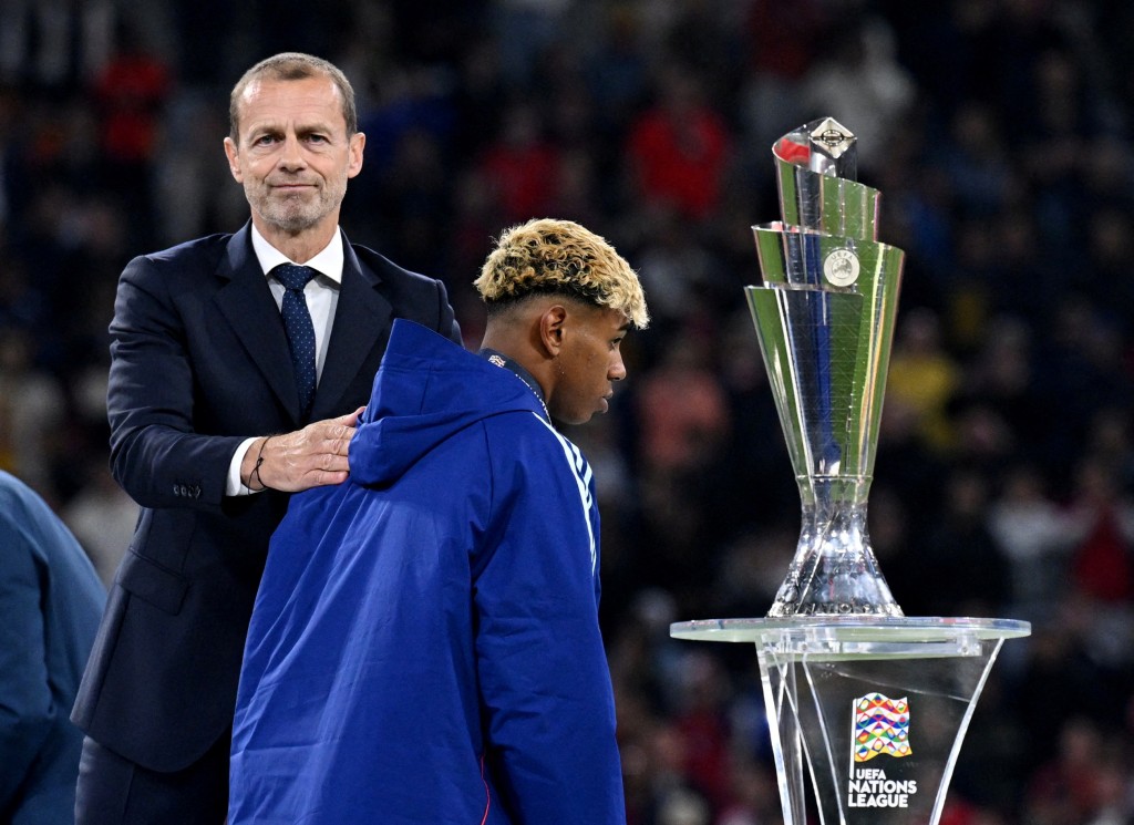 Spain's Lamine Yamal looks dejected walking past the trophy as he is consoled by UEFA president Aleksander Ceferin. (Reuters)