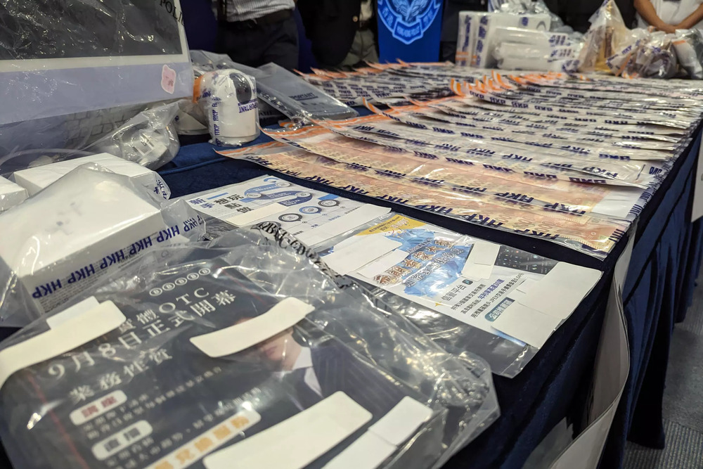 Police on Monday conducted a high-profile raid of 20 premises, seizing cash, computer equipment and luxury handbags. (AFP) Police on Monday conducted a high-profile raid of 20 premises, seizing cash, computer equipment and luxury handbags. (AFP)