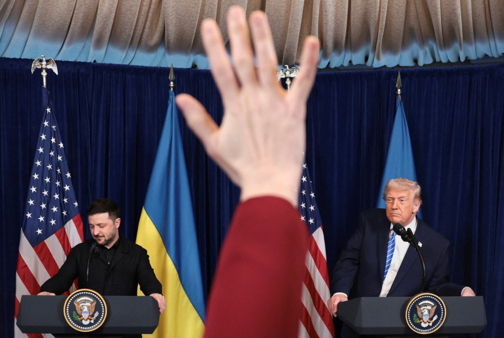A reporter raises a hand to ask a question during a press conference held by Ukrainian President Volodymyr Zelenskiy and U.S. President Donald Trump after their lunch meeting at Trump's Mar-a-Lago club, in Palm Beach, Florida, U.S., December 28, 2025. (Reuters)