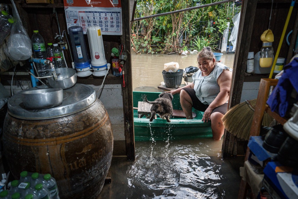 Photo by CHANAKARN LAOSARAKHAM / AFP  Ayutthaya resident Yupin Nakbanlang, 57, sits in her boat in front of the entrance of her flooded home in Bang Ban district, in the central Thai province of Ayutthaya on October 6, 2026.
