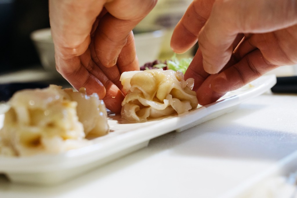 A chef prepares geoduck sashimi at a restaurant in Hong Kong. The geoduck's rarity has secured its position as a status symbol at banquets and celebrations. (Bloomberg)