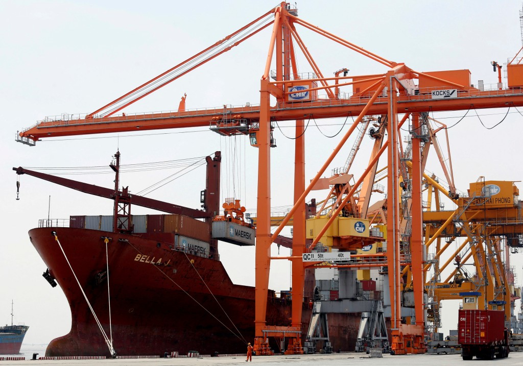 Shipping containers are loaded to a ship at a port in Hai Phong city, Vietnam July 12, 2018. REUTERS
