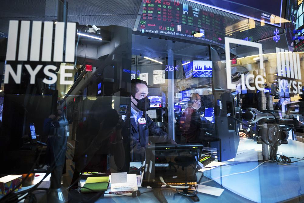 In this photo provided by the New York Stock Exchange, trader Robert Greason, left, right, works on the floor, Thursday April 22, 2021. Stocks wobbled between small gains and losses Thursday as investors continue to focus on company earnings reports and the economic recovery. In this photo provided by the New York Stock Exchange, trader Robert Greason, left, right, works on the floor, Thursday April 22, 2021. Stocks wobbled between small gains and losses Thursday as investors continue to focus on company earnings reports and the economic recovery.