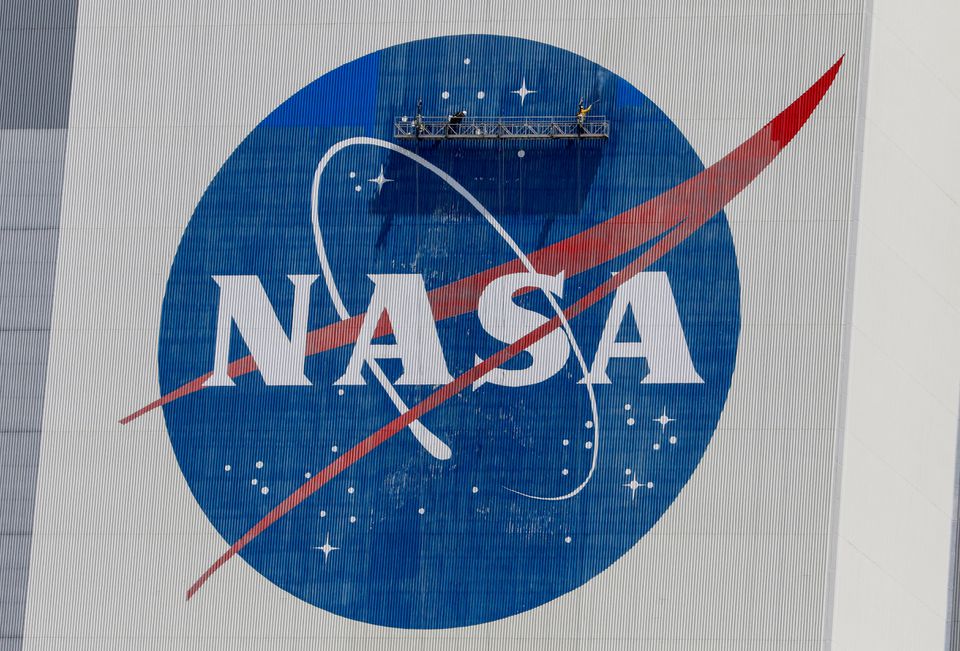 Workers pressure wash the logo of NASA on the Vehicle Assembly Building. (Reuters) Workers pressure wash the logo of NASA on the Vehicle Assembly Building. (Reuters)