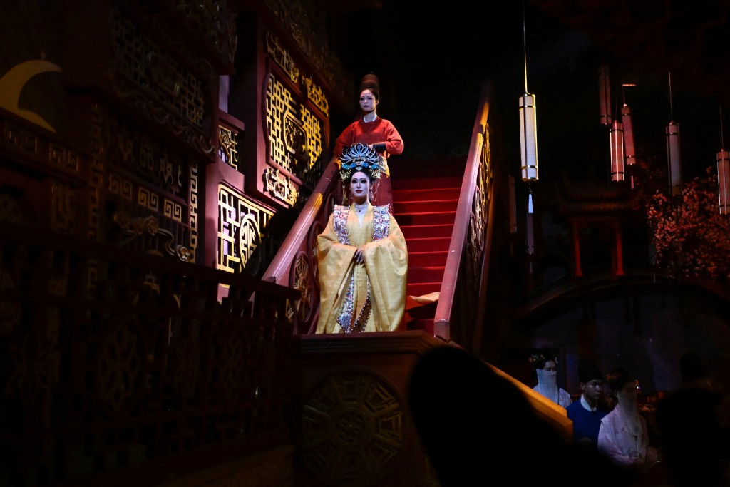 Photo by WANG ZHAO / AFP  This picture taken on November 5, 2025 shows artists in traditional Chinese clothes performing at a theatrical restaurant in Beijing.