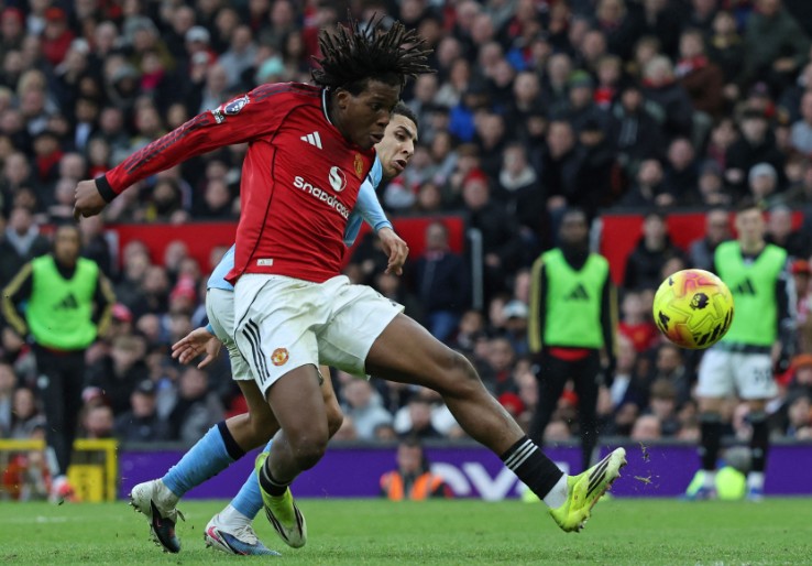 Patrick Dorgu shoots to score United’s second goal against City during the derby at Old Trafford. AFP