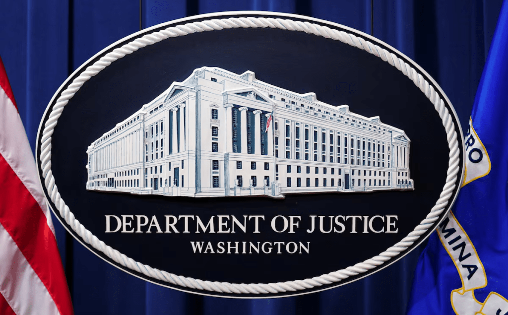 A U.S. Justice Department logo or seal showing Justice Department headquarters, known as "Main Justice," is seen behind the podium in the Department's headquarters briefing room before a news conference with the Attorney General in Washington, January 24, 2023. REUTERS/Kevin Lamarque