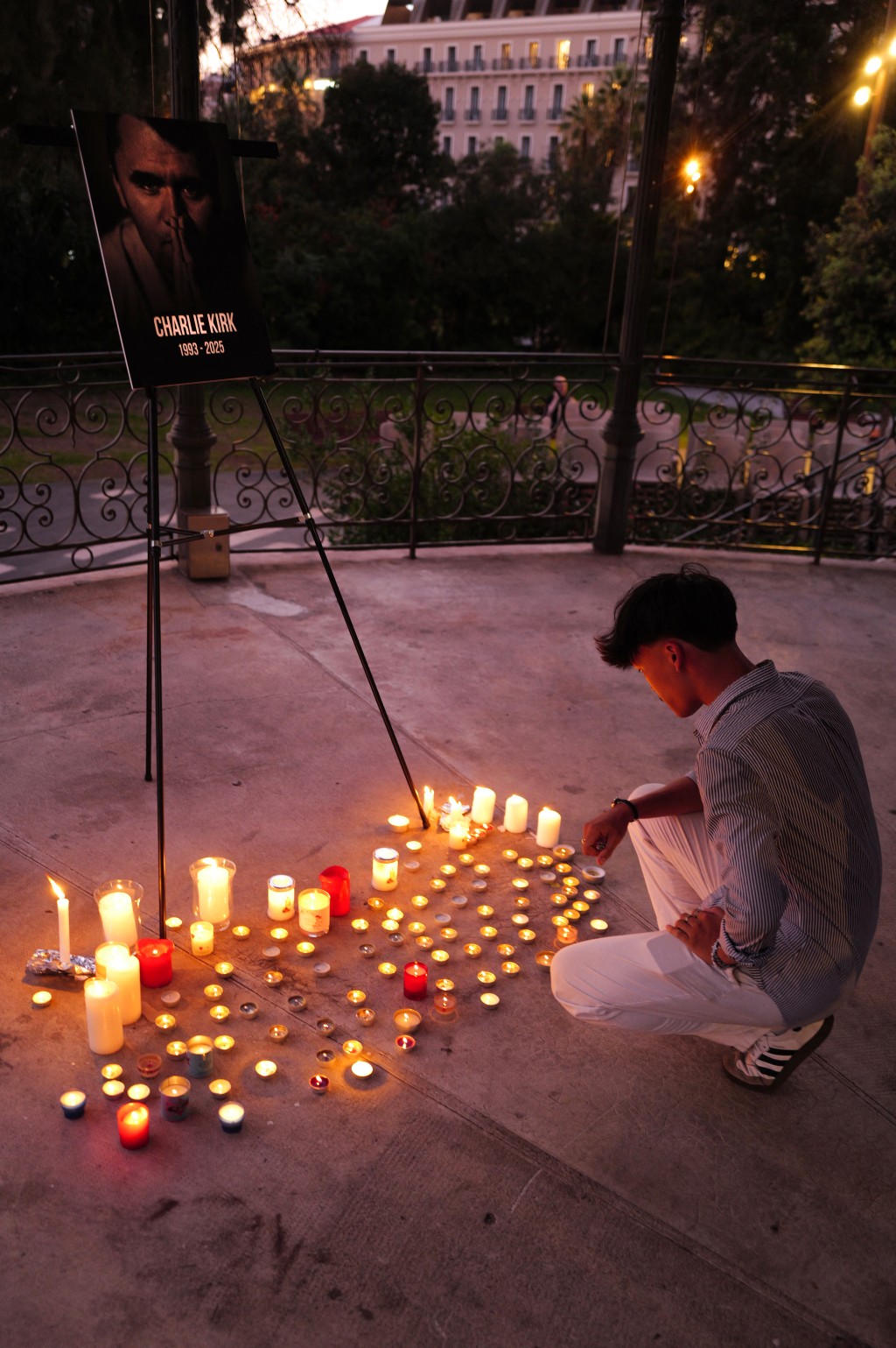 A man lights up a candle during a vigil in tribute to Turning Point USA Founder Charlie Kirk in the French Riviera city of Nice, on September 17, 2025. Kirk, a close ally of US President Donald Trump, was shot on September 10 during a speaking event on a Utah university campus. He was the founder of the hugely influential conservative youth political group Turning Point USA. (Photo by Valery HACHE / AFP)
