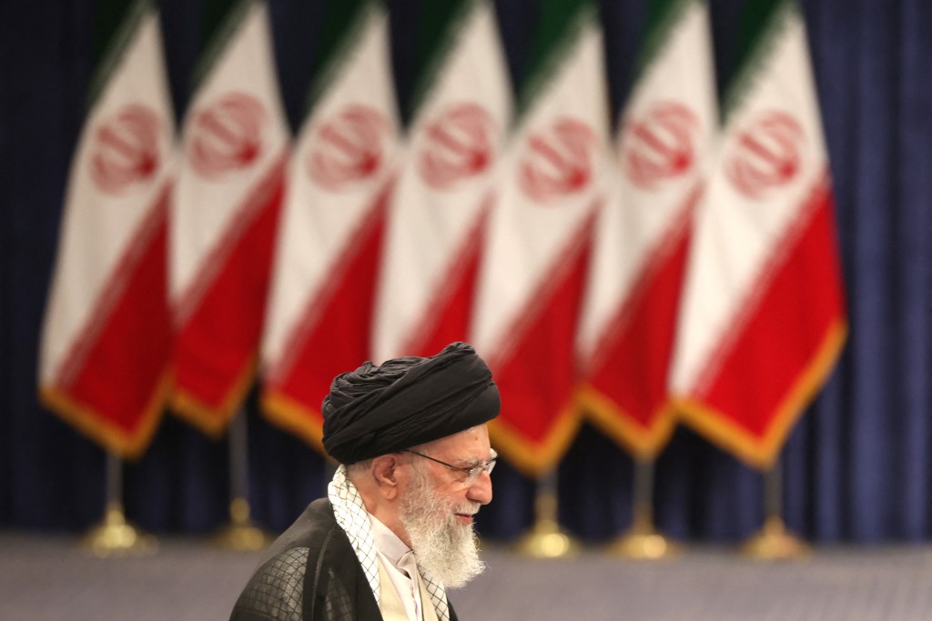 Iran's supreme leader Ayatollah Ali Khamenei walks to the podium to address the media after casting his ballot during the Islamic republic's presidential election in Tehran on June 28, 2024. (AFP)