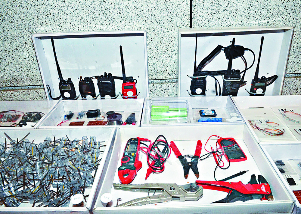 Explosive ordnance police deploy at the scene in December. Top: part of the explosive device seized near Wah Yan College that day and some of the equipment allegedly seized from the suspect's home in Sau Mau Ping. Explosive ordnance police deploy at the scene in December. Top: part of the explosive device seized near Wah Yan College that day and some of the equipment allegedly seized from the suspect's home in Sau Mau Ping.
