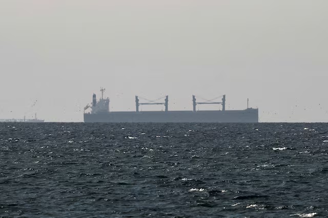 A cargo ship in the Gulf, near the Strait of Hormuz, as seen from northern Ras al-Khaimah, near the border with Oman’s Musandam governance, amid the U.S.-Israeli conflict with Iran, in United Arab Emirates, March 11, 2026. REUTERS/Stringer/File Photo Purchase Licensing Rights