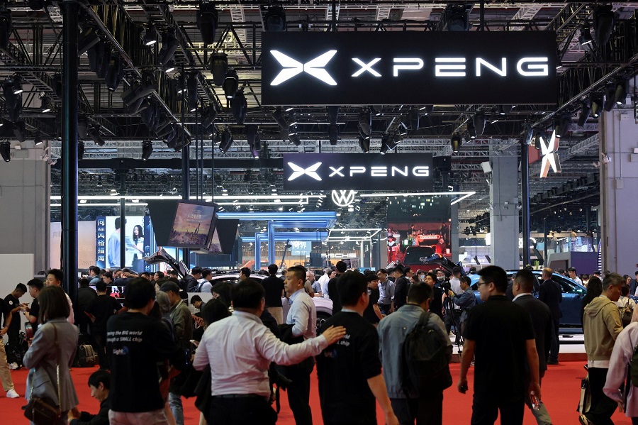 People walk by the Xpeng booth during a media day for the Auto Shanghai show in April. Photo by REUTERS