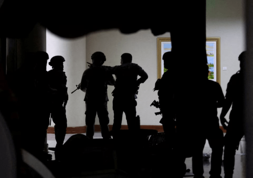 Military personnel in camouflage fatigues enter the Senate building where Philippine Senator Ronald "Bato" dela Rosa, the chief enforcer of former president Rodrigo Duterte's drug war, at the Senate, is under protective custody amid an International Criminal Court warrant, as more than a dozen gunshots were heard at the Philippine Senate on Wednesday, and people were told to run for cover, according to a Reuters witness, in Pasay City, Metro Manila, Philippines, May 13, 2026. REUTERS/Eloisa Lopez TPX IMAGES