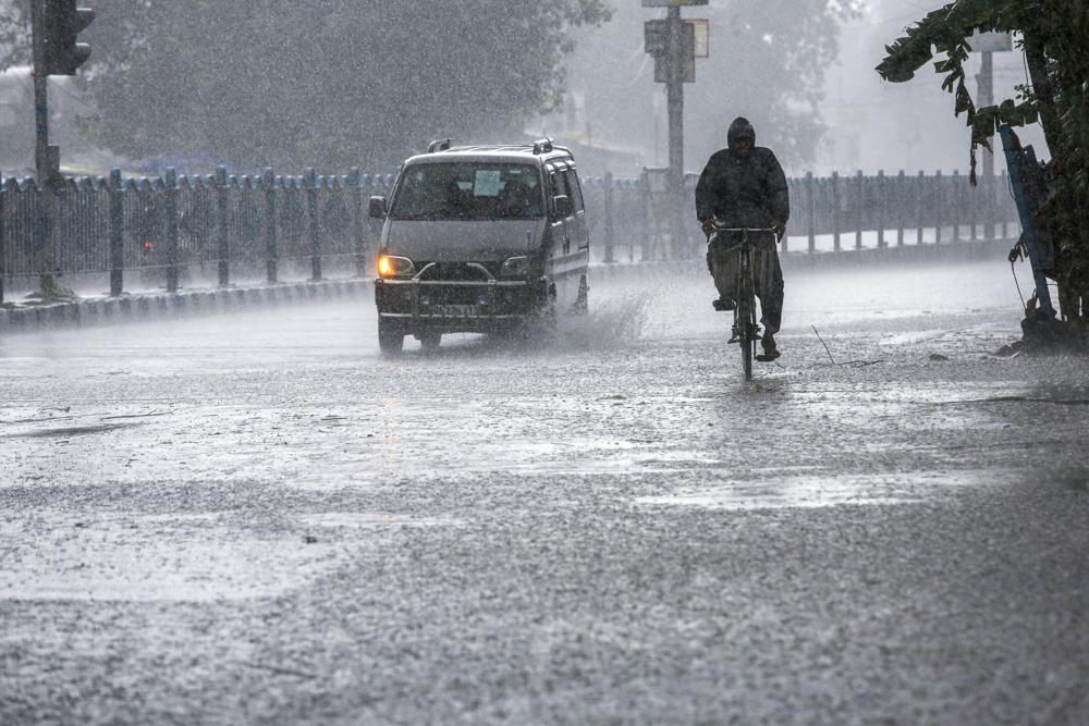 A man pedals through heavy rain under the inclement weather due to Cyclone Yaas in Kolkata, India, Wednesday, May 26, 2021. A man pedals through heavy rain under the inclement weather due to Cyclone Yaas in Kolkata, India, Wednesday, May 26, 2021.