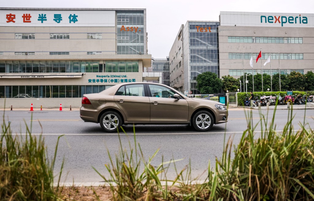 A car drives by Nexperia factory amidst a shortage of chip supply caused by the diplomatic standoff between China and the Netherlands over the company, in Dongguan, Guangdong province, China, November 7, 2025. REUTERS/Maxim Shemetov