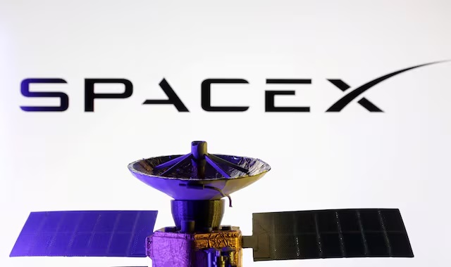 SpaceX logo and miniature satellite model are seen in this illustration taken, March 10, 2025. REUTERS/Dado Ruvic/Illustration/File Photo