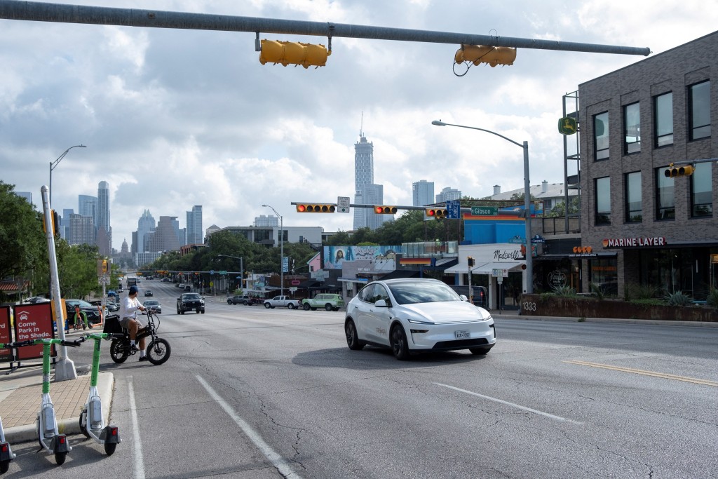 A Tesla robotaxi drives on the street along South Congress Avenue in Austin, Texas, U.S., June 22, 2025. REUTERS
