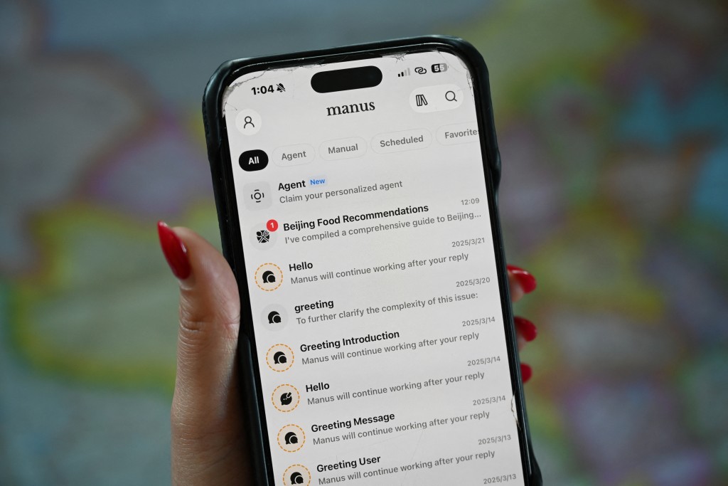 Photo by GREG BAKER / AFPThis photo illustration shows the Manus app on a mobile phone in Beijing on April 28, 2026.