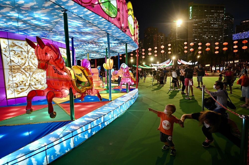 Parents bring their children to local parks where colorful lanterns celebrating Mid-Autumn Festival will light up until September 22.