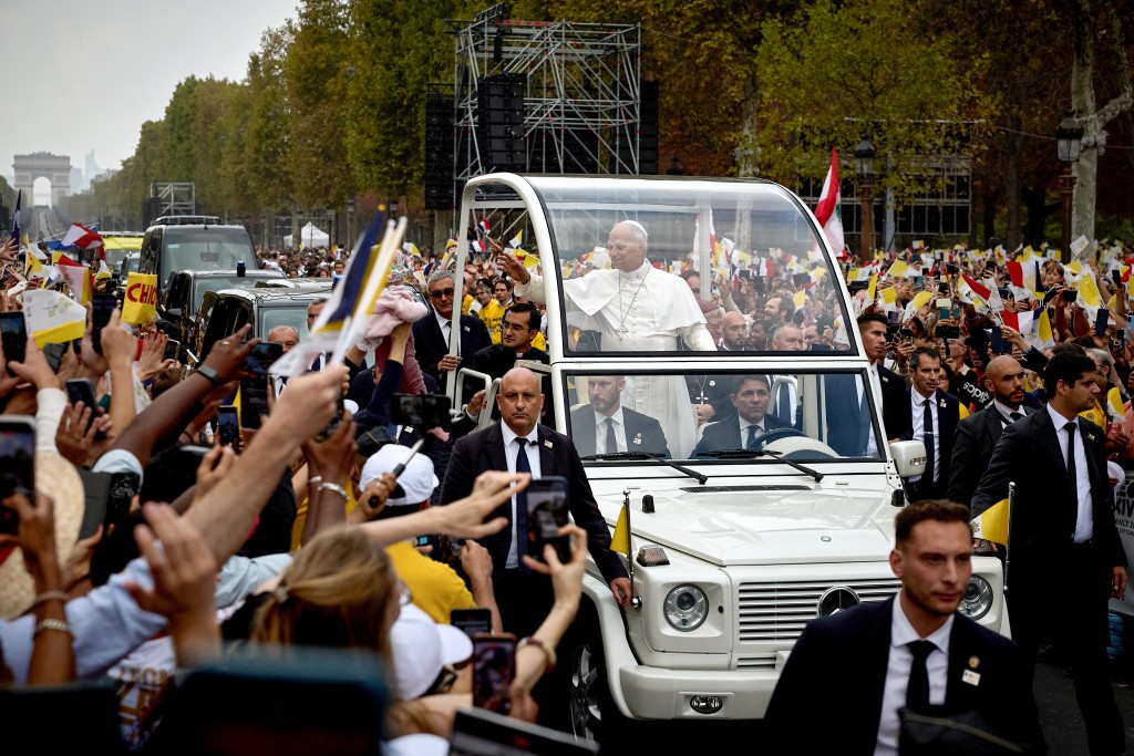 Pope Leo XIV waves to the crowd from the Papamobile (popemobile) as he rides down the Champs-Elysees Avenue to arrive to celebrate a solemn outdoor mass at Place de la Concorde, central Paris, on September 26, 2026 on the second day of his visit to France. (AFP)